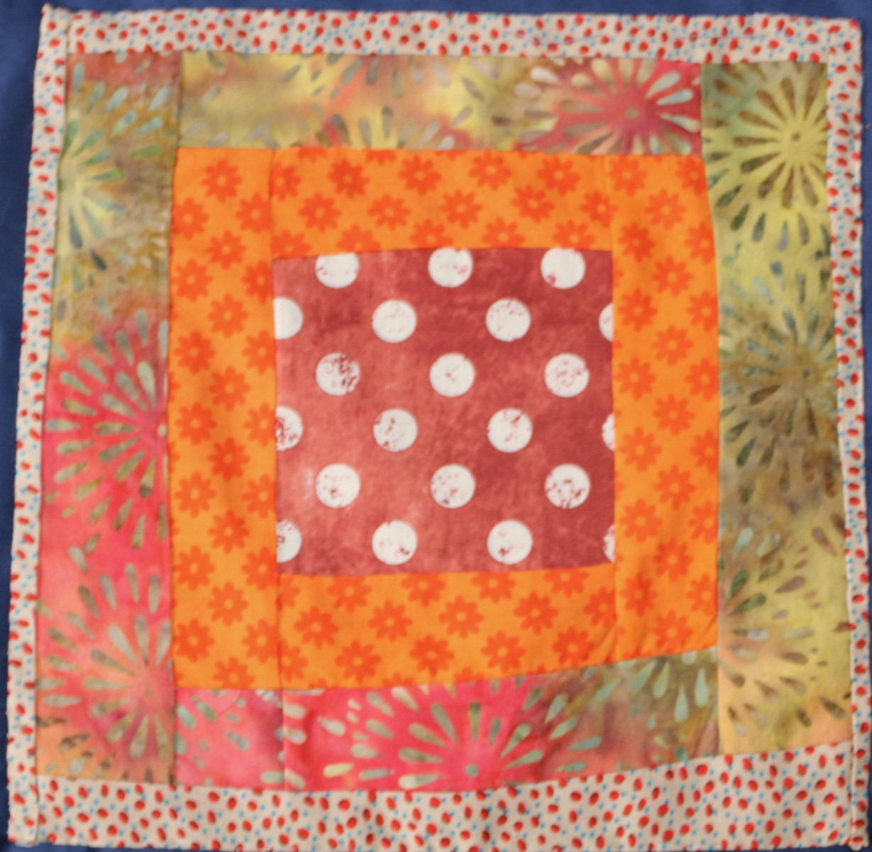 Patchwork square in reds and orange