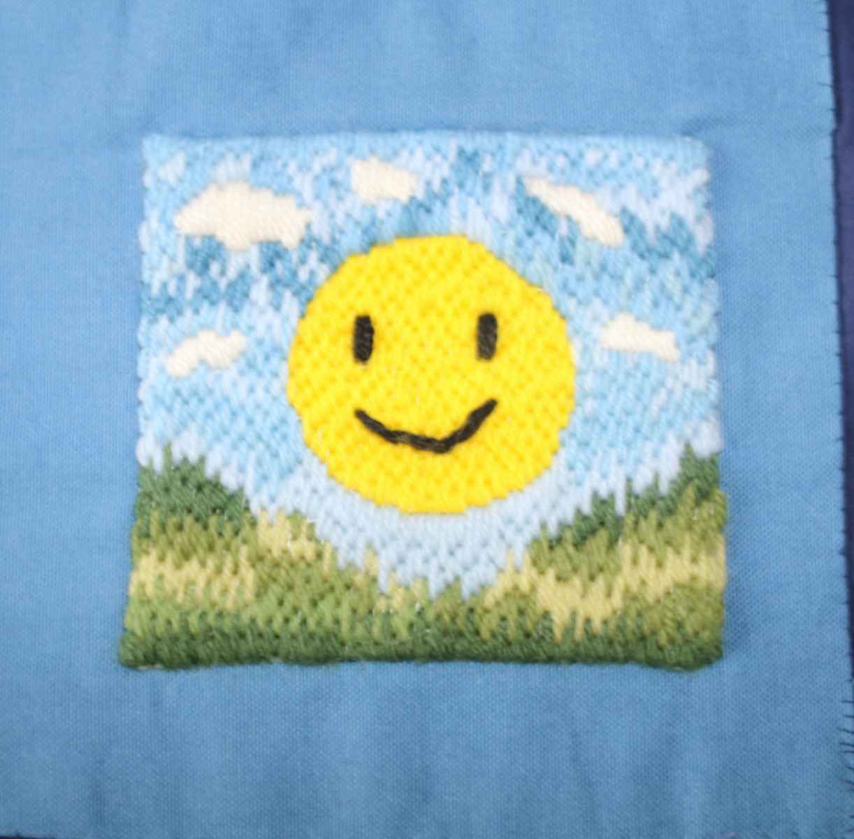 Embroidery of a smiling sun