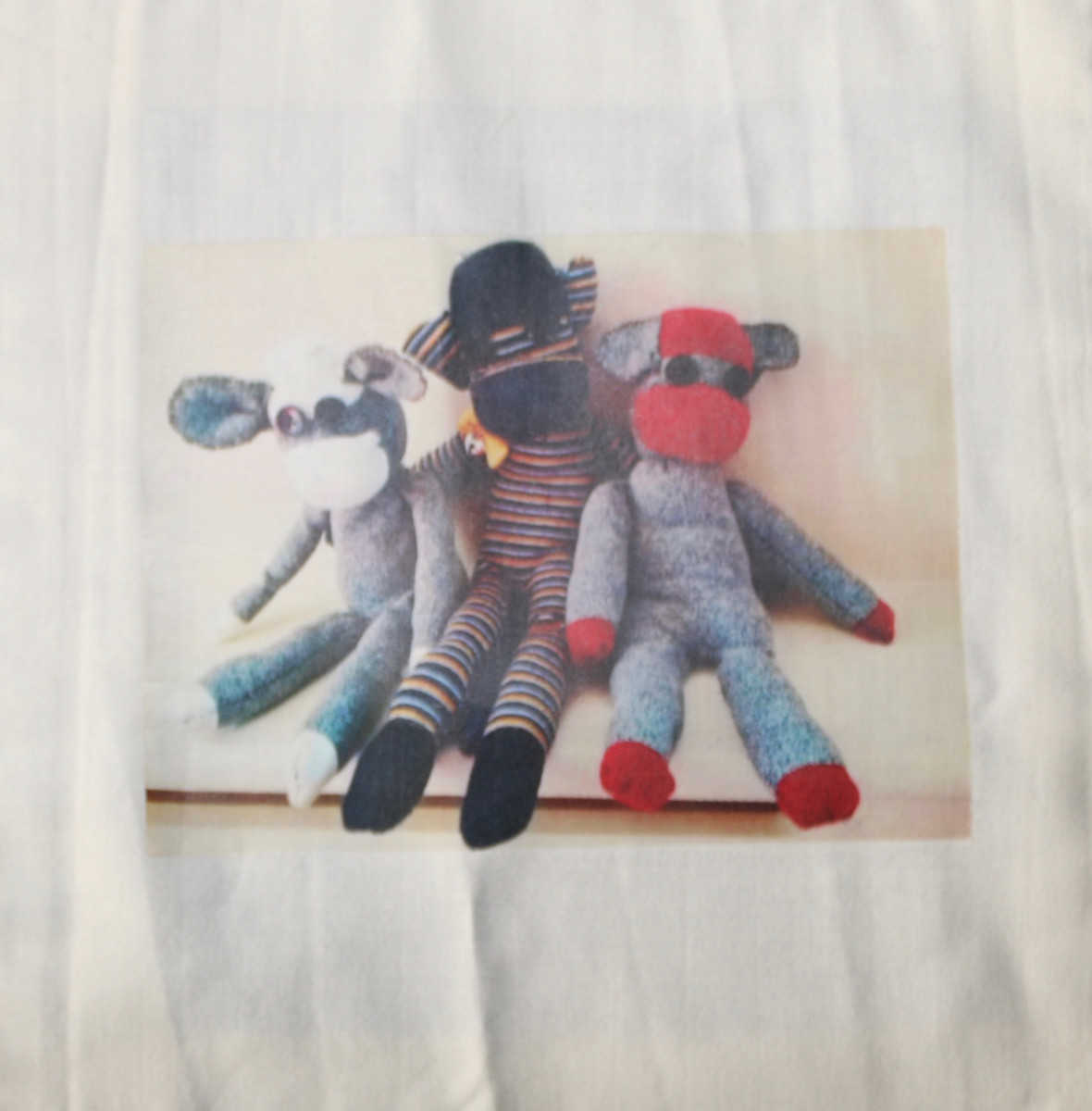 Photo of 3 sock monkeys sat together